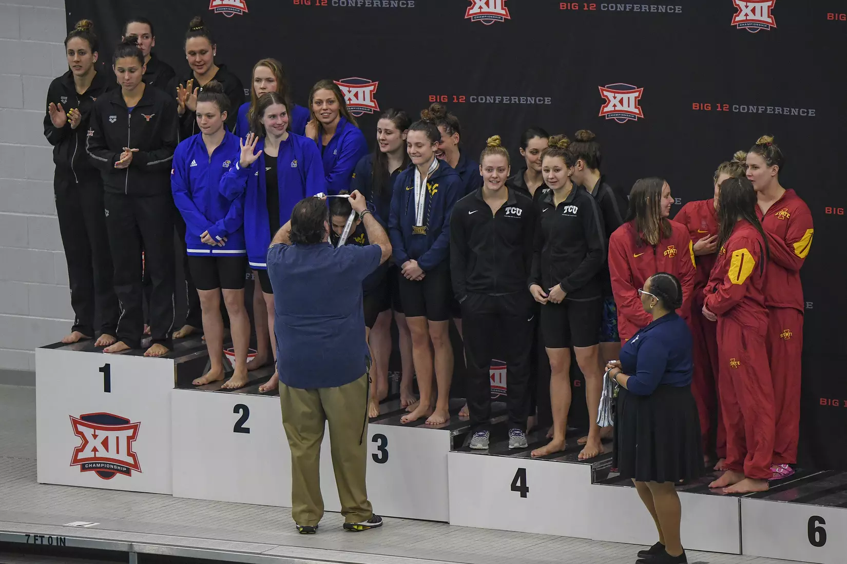 Vic Riggs awards third place medals to his women's 400 yard freestyle team.