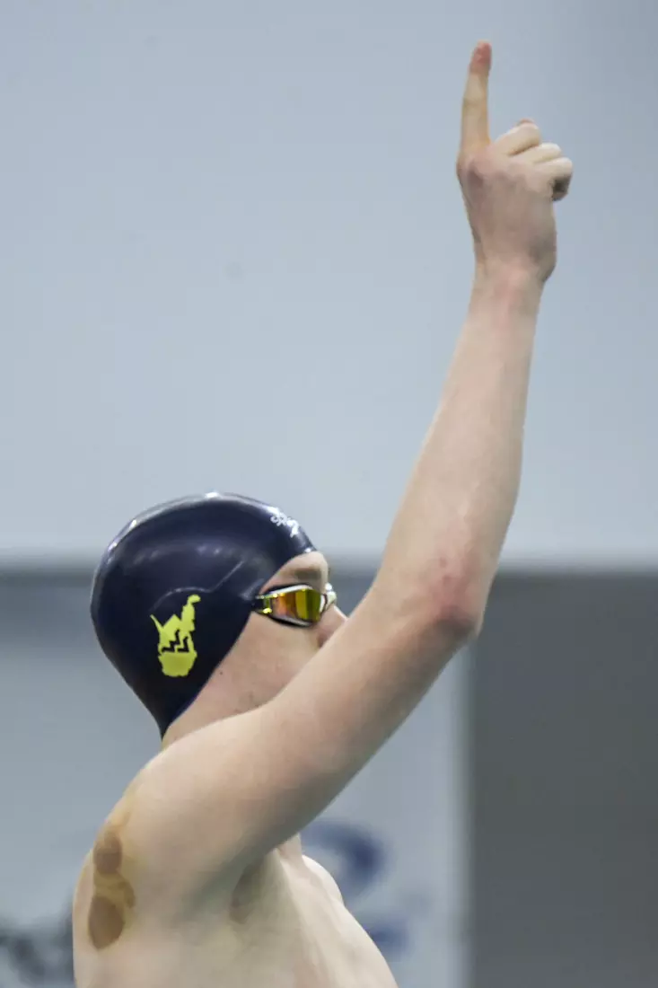 Hunter Armstrong points upward before the start of the 400 free relay.