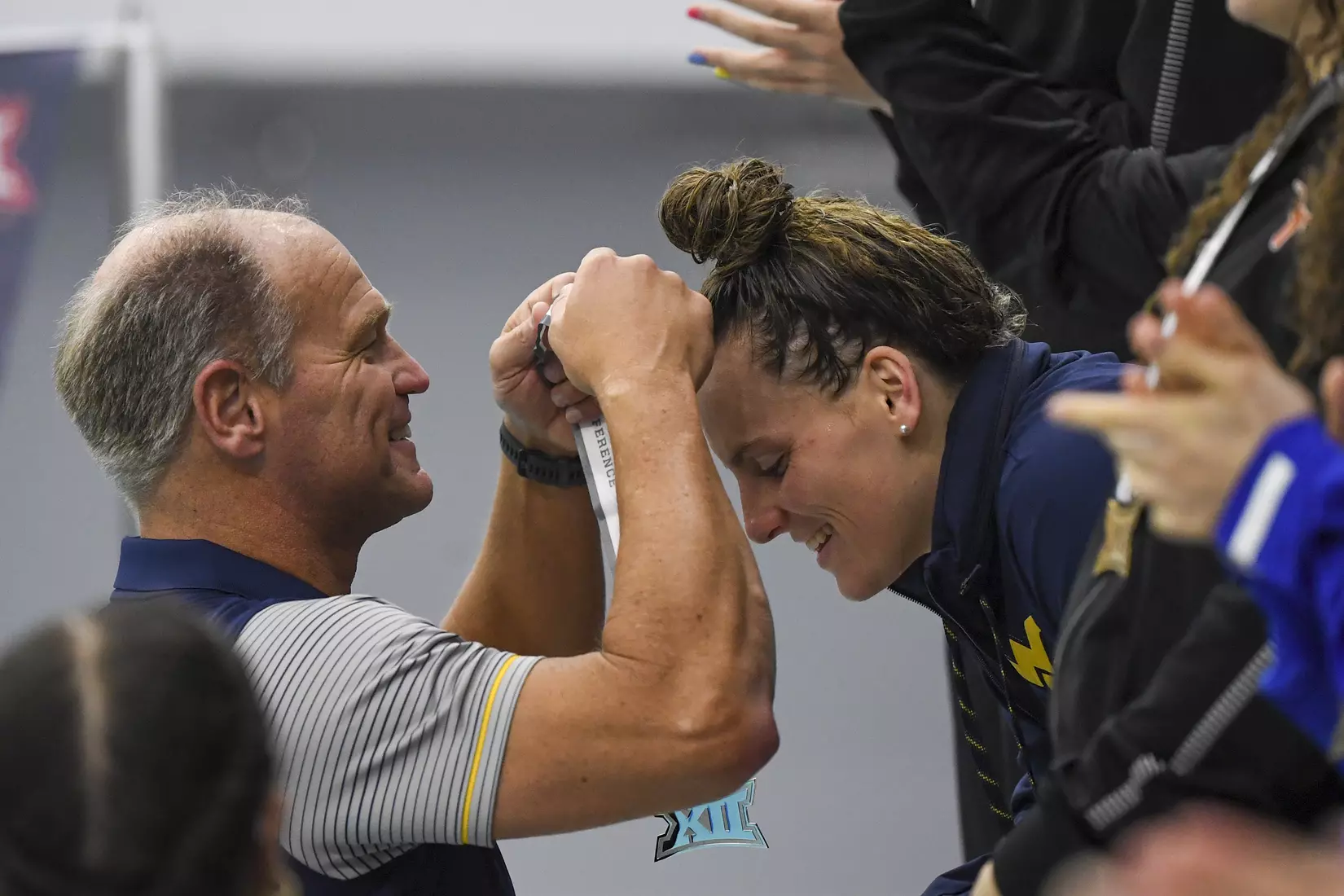 Morgan Bullock receives her second place medal for the 200 Yard Butterfly.