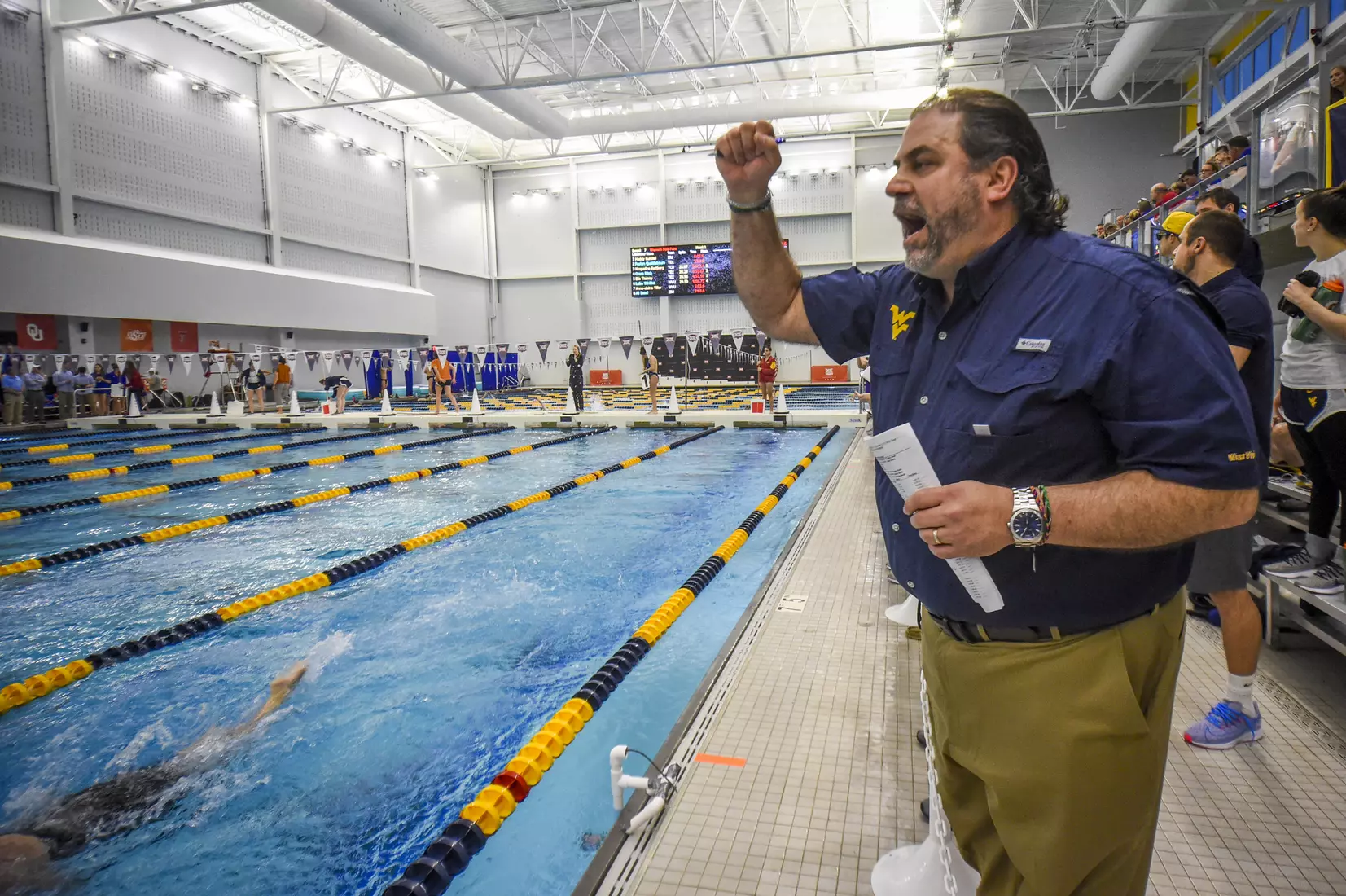 Head coach Vic Riggs cheers on his team.