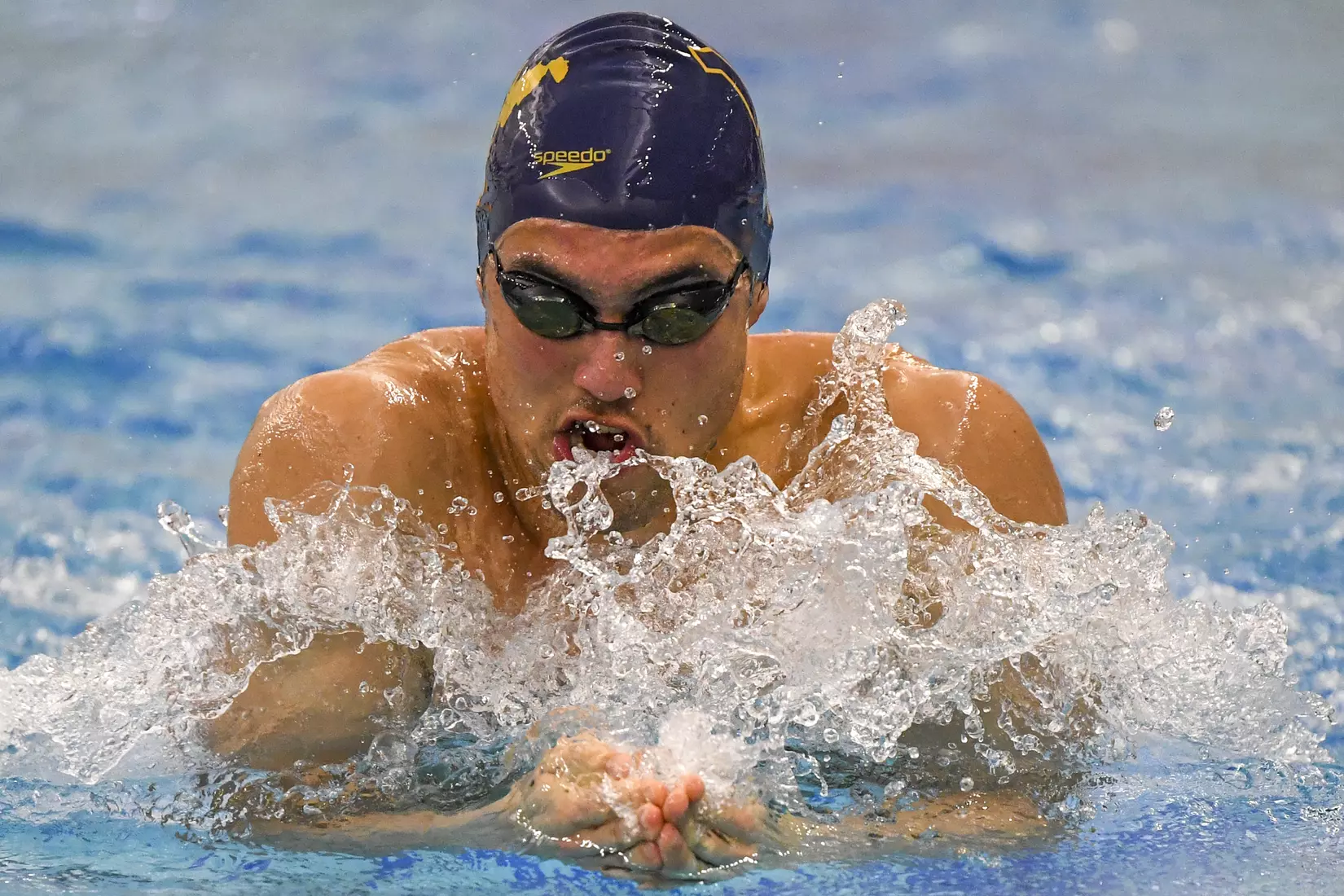 Fausto Huerta swims to a third place finish in the 100 yard breaststroke.