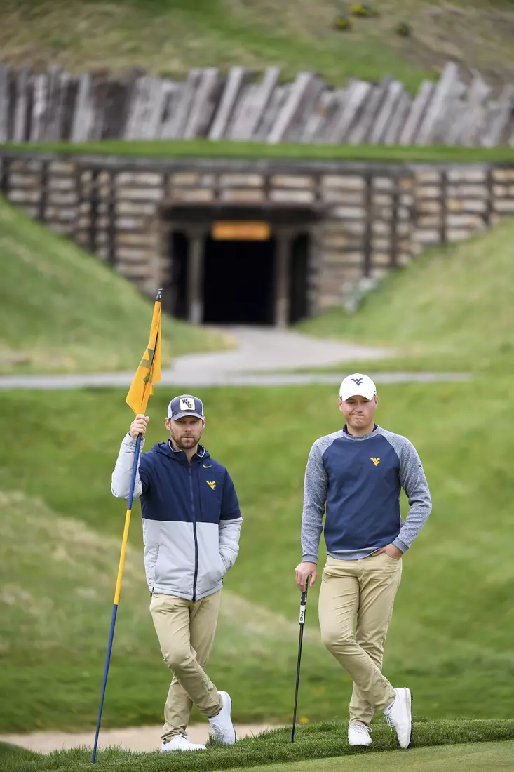 Coach Clay Bounds and Kurtis Grant watch from greenside on seven.