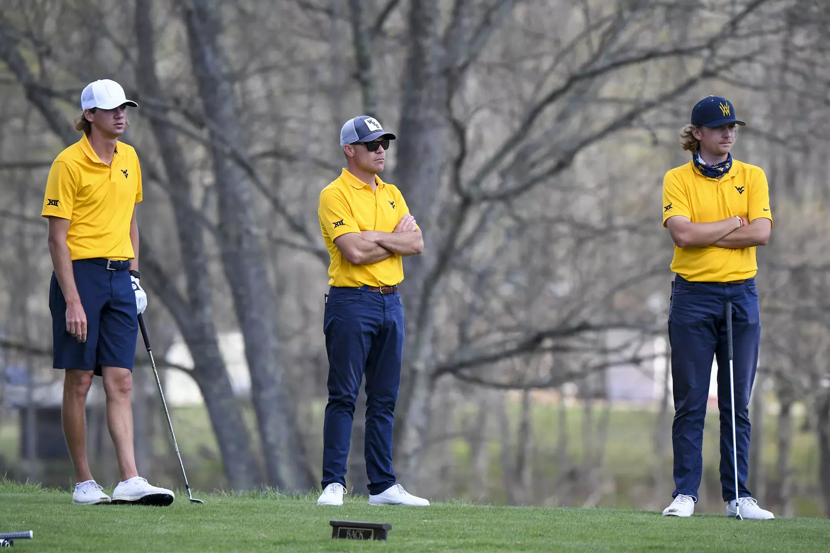 Mark Goetz, head coach Sean Covich and Jackson Davenport wait on the fourth tee.