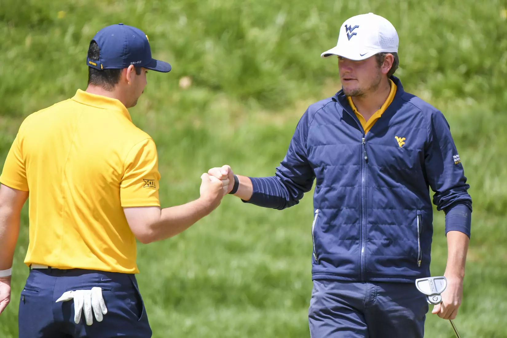 Logan Perkins fist bumps teammate Etienne Papineau.