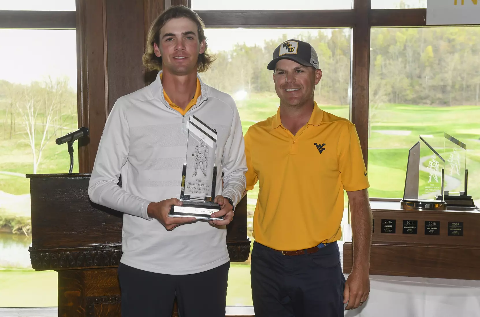 Individual medalist Mark Goetz is congratulated by head coach Sean Covich.