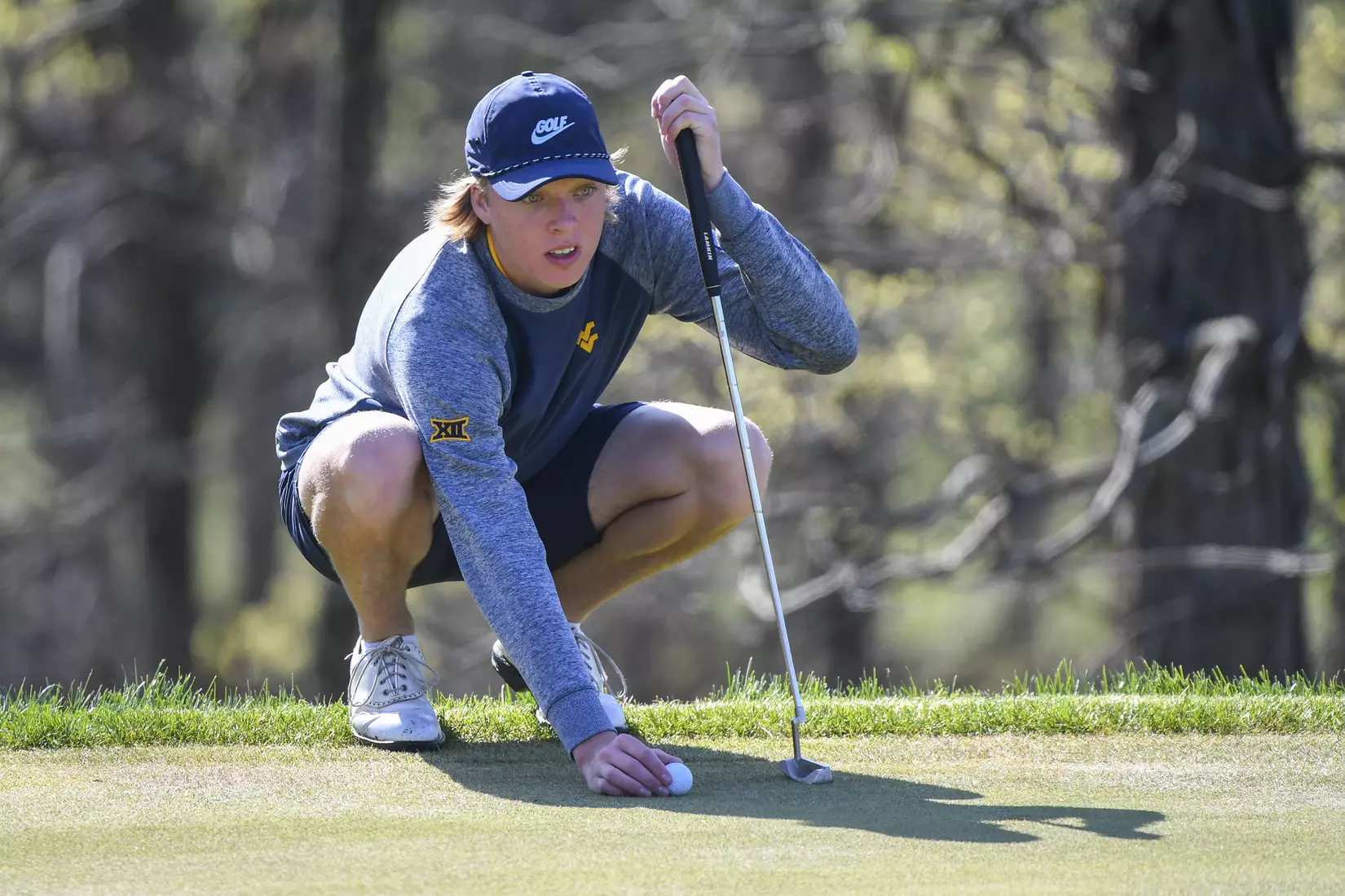 Oliver Menard sets his ball on the green.