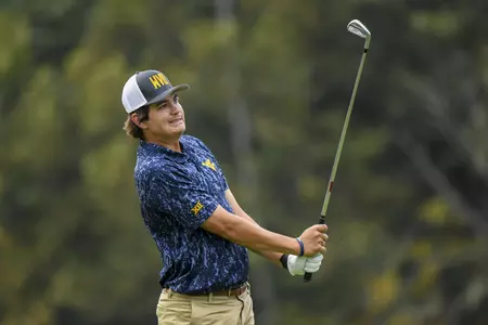 Will Stakel watches his tee shot on the par three fourth hole.