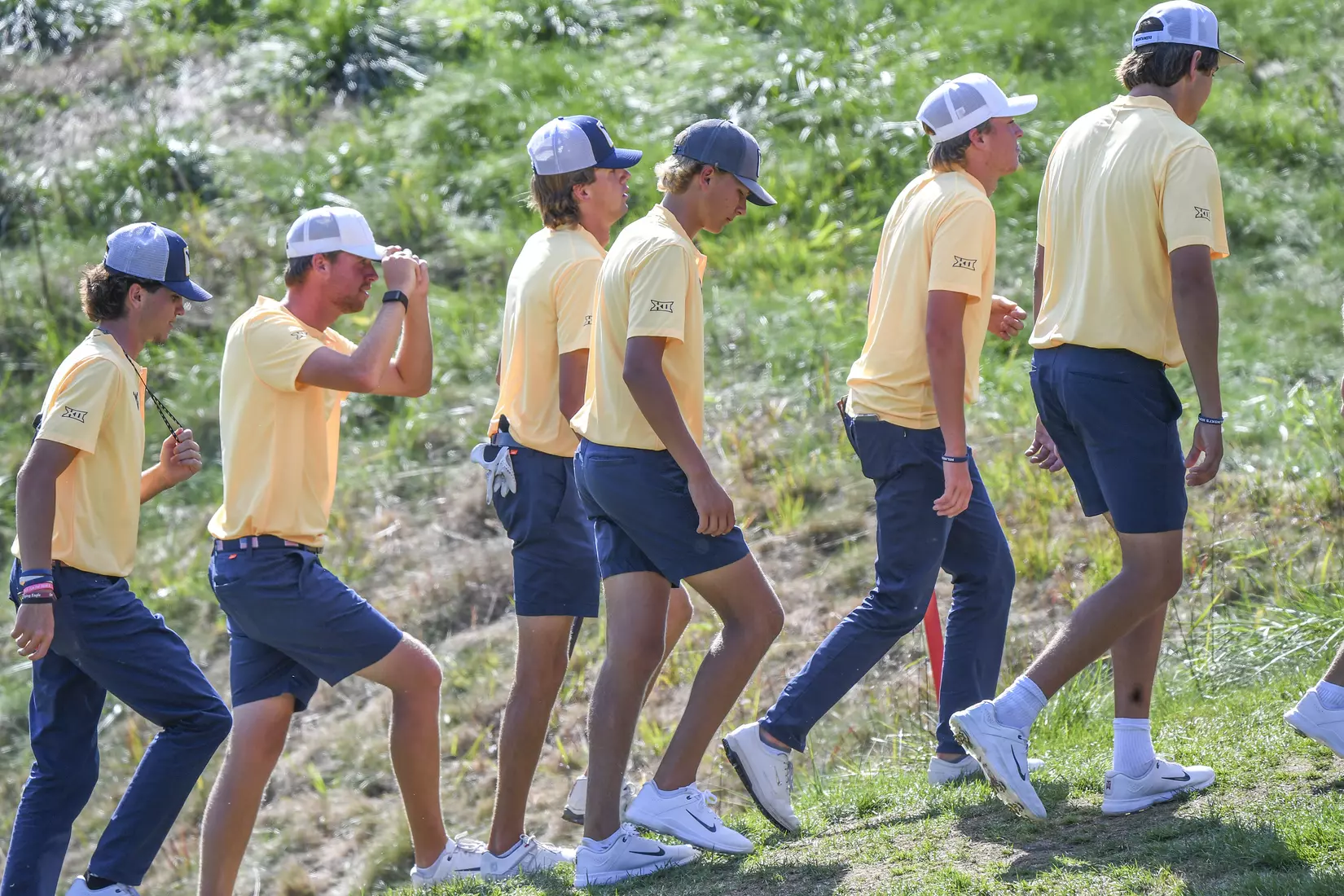 The Mountaineers escort their leader, Mark Goetz, up the hill following his finish on 18.