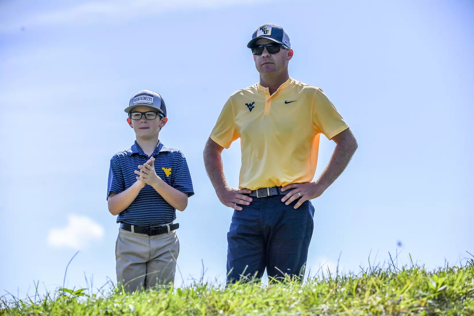 Coach Sean Covich and his son Keenan watch the action at Pete Dye Golf Club.
