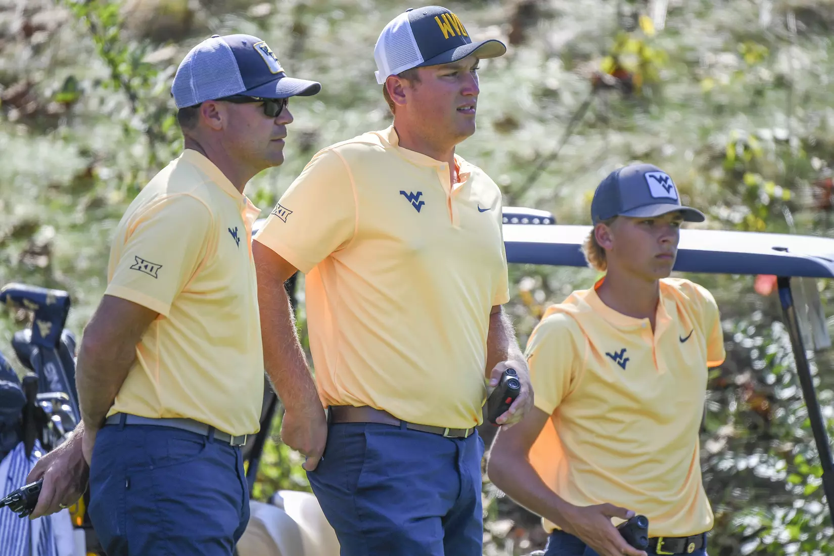Coach Sean Covich talks with Kurtis Grant and Max Green on the 16th hole.