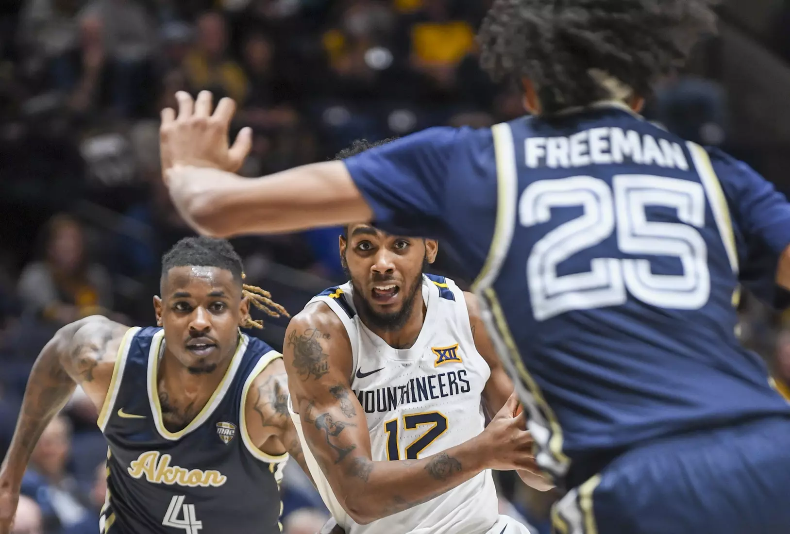 Taz Sherman drives between two defenders.