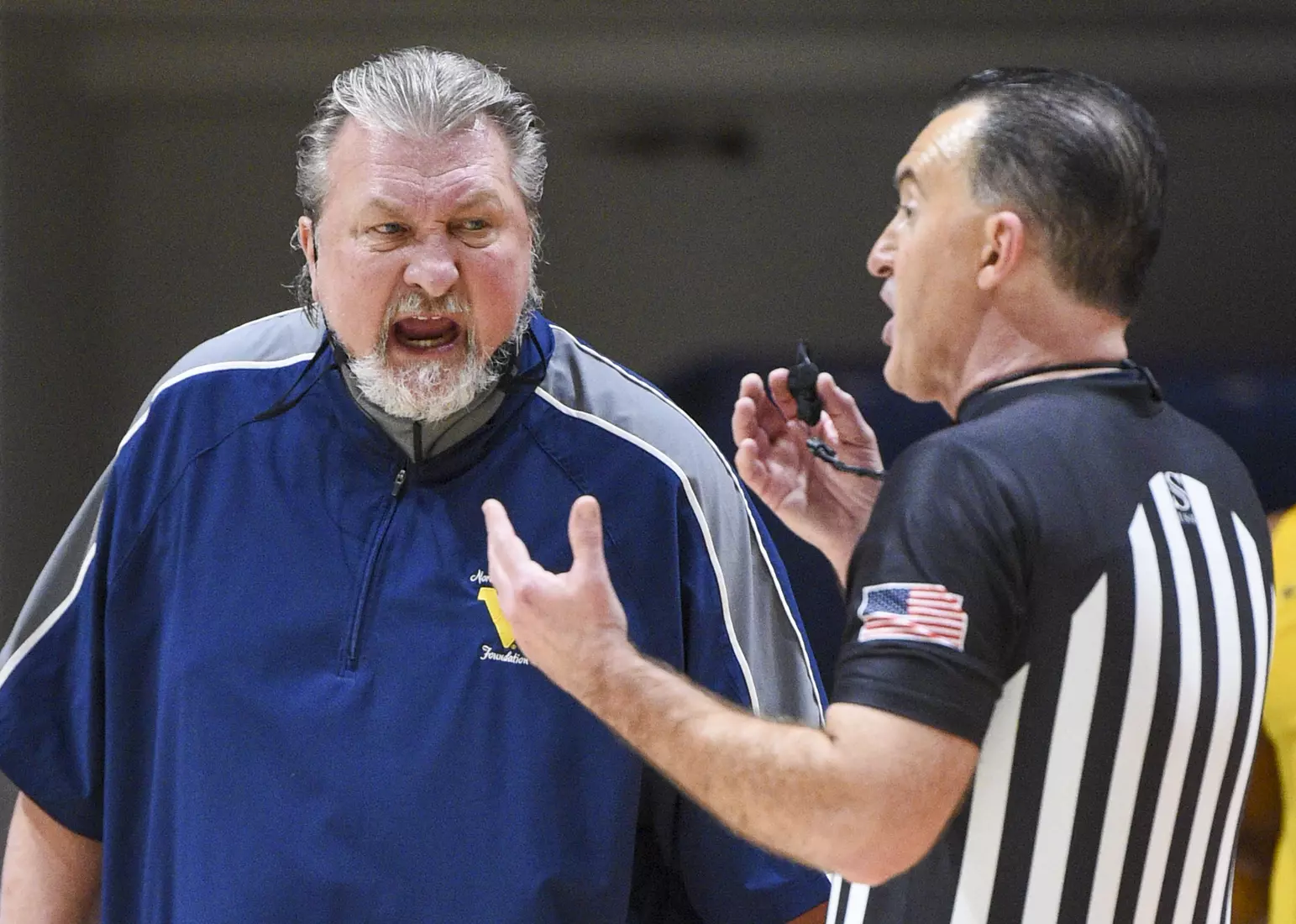 Bob Huggins talks with referee Roger Ayers.