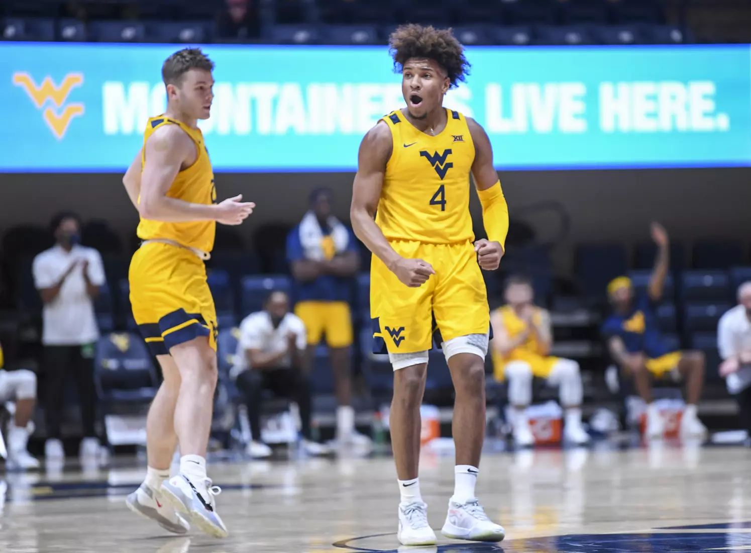 Miles McBride and Sean McNeil celebrate a three-pointer.