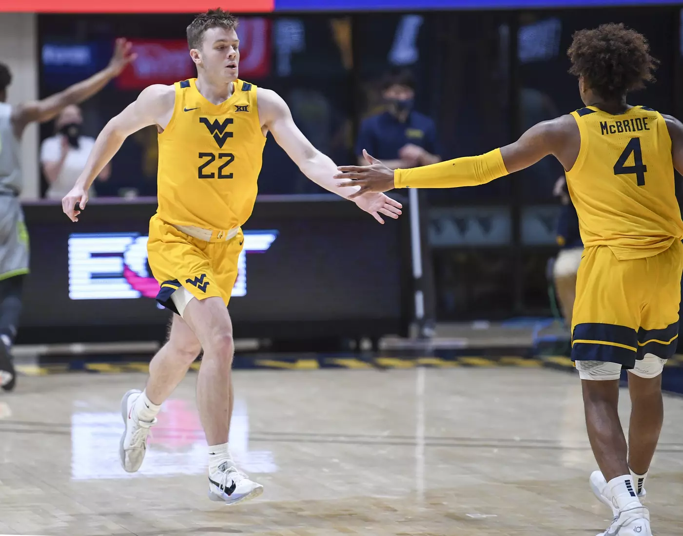 Sean McNeil is congratulated by Miles McBride after a three-pointer.