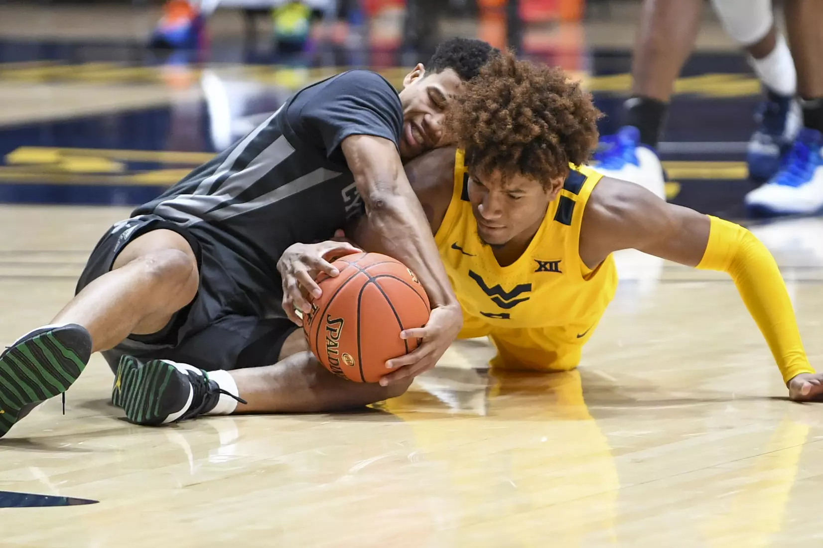 Miles McBride wrestles for a loose ball.