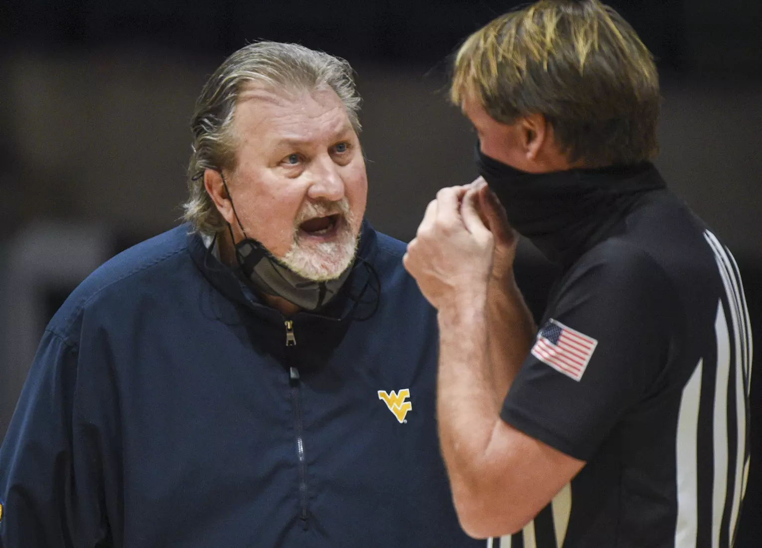 Bob Huggins has a discussion with official John Higgins.