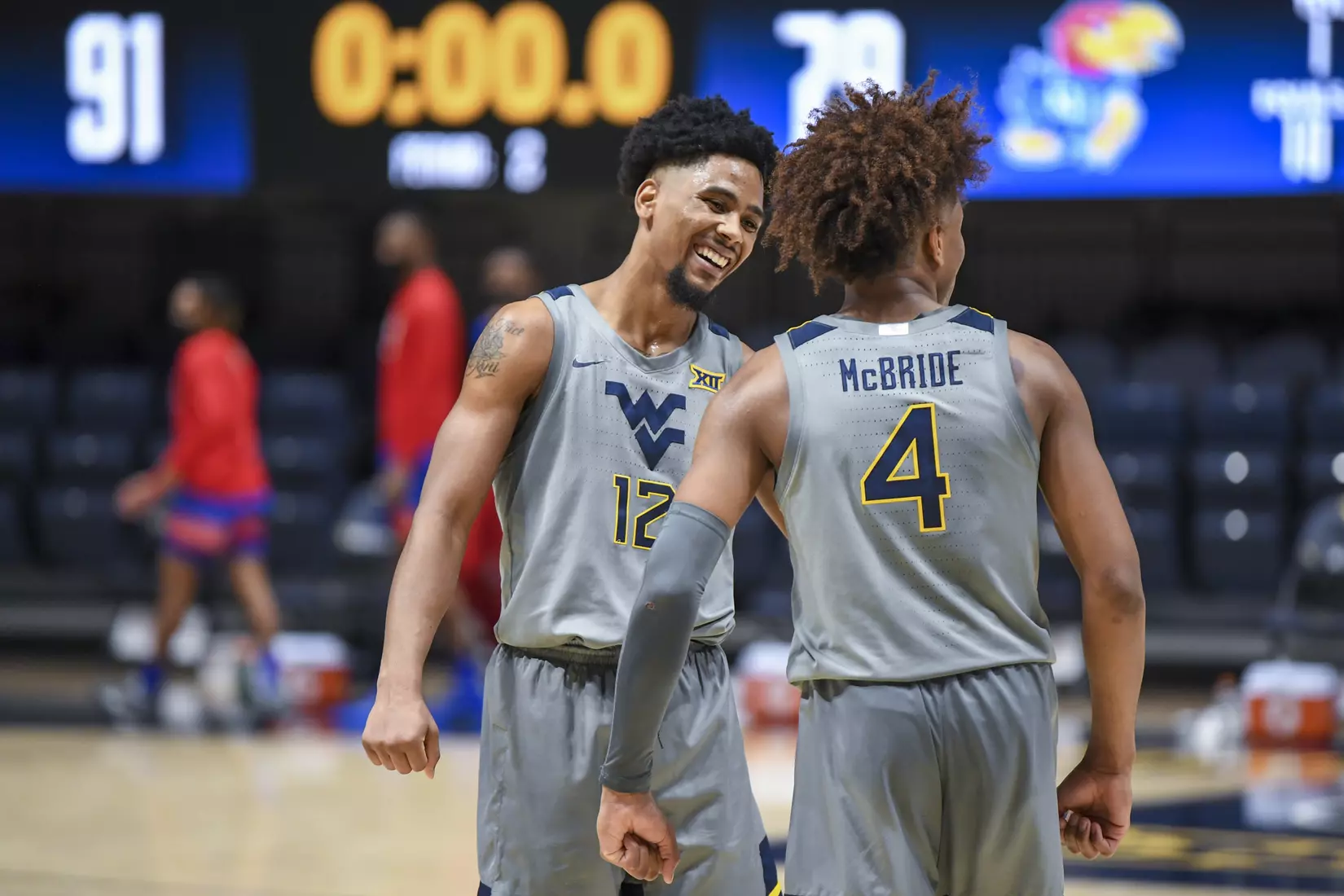 Taz Sherman and Miles McBride celebrate the win.