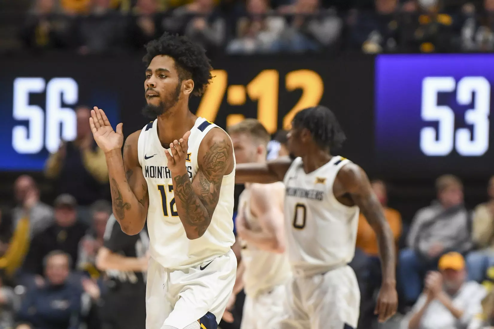 Taz Sherman claps after taking the lead with a three.