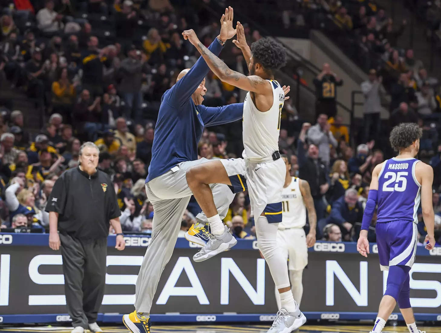 Assistant coach Erik Martin and Taz Sherman celebrate during a time out.