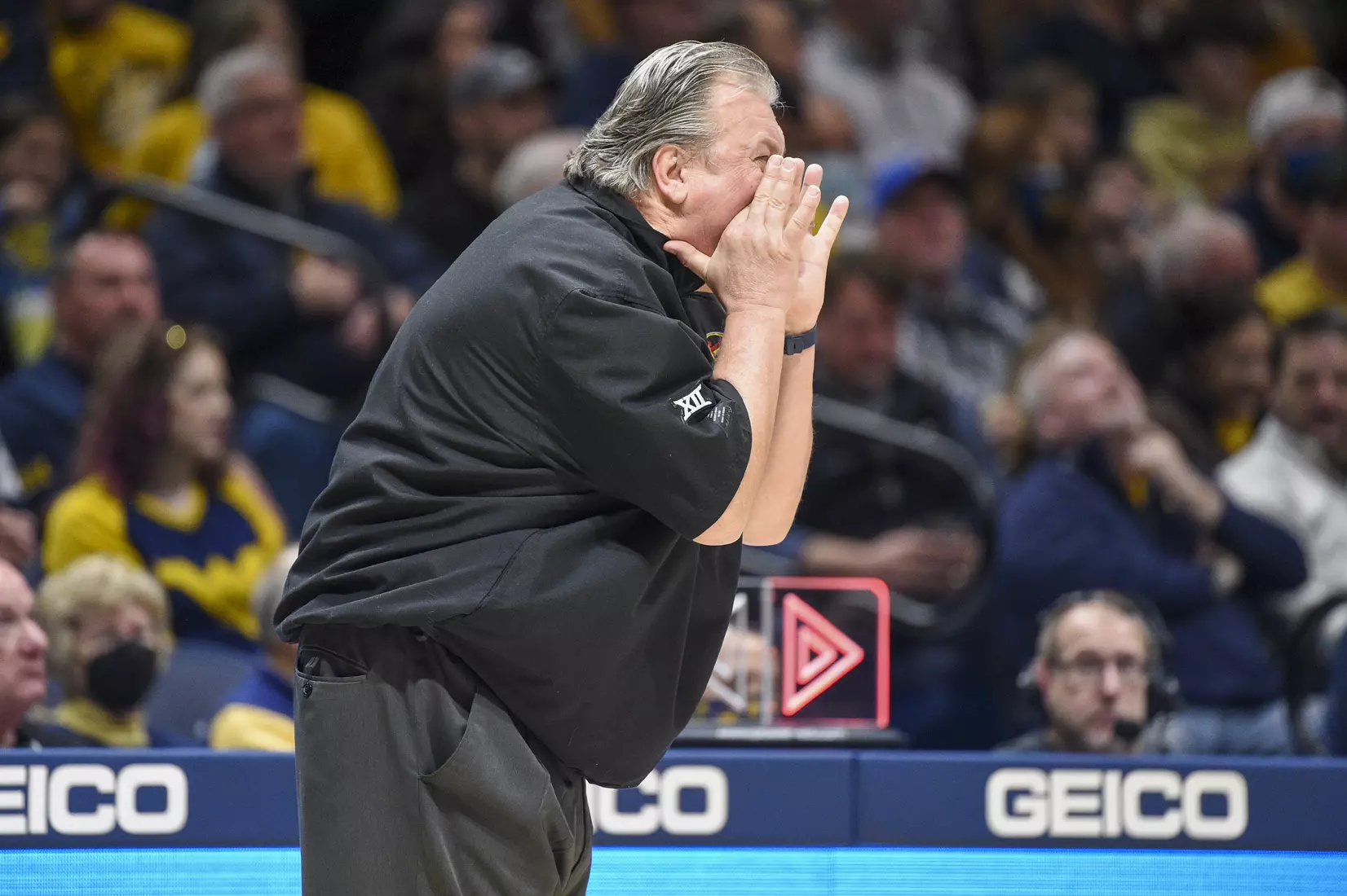 Bob Huggins speaks to the officials.