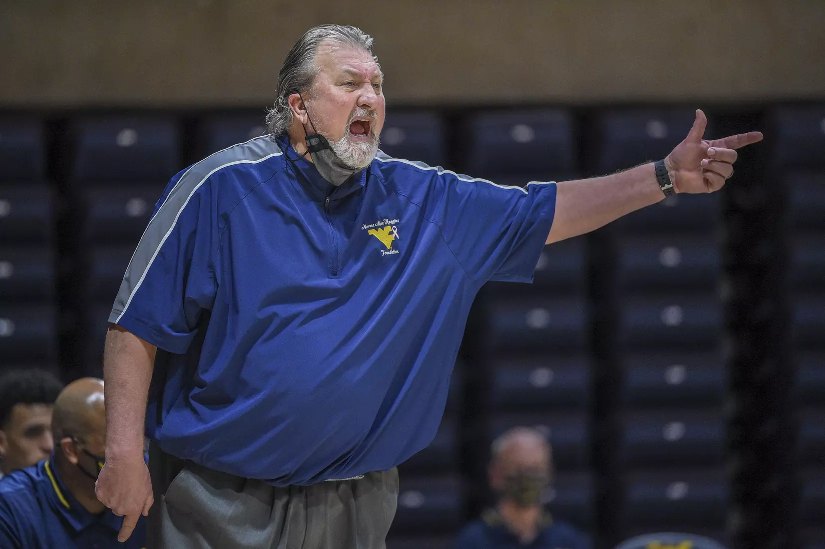 Bob Huggins communicates with the officiating crew.