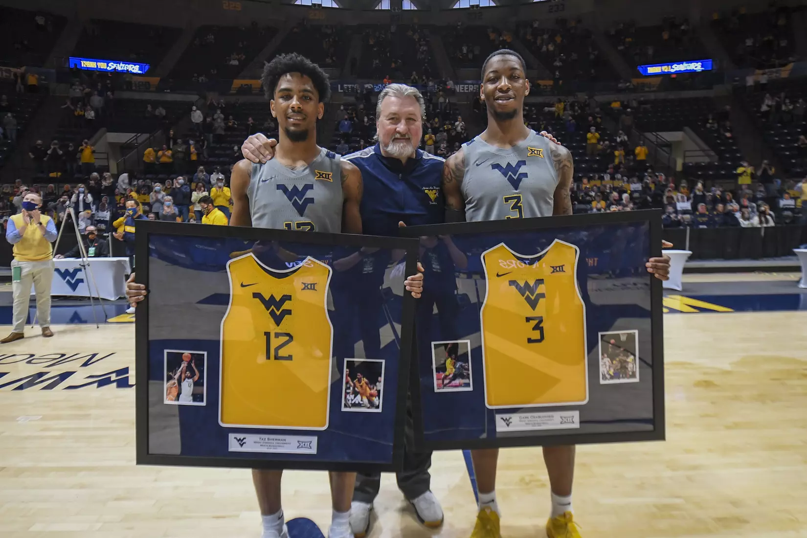 Seniors Taz Sherman and Gabe Osabuohien with Bob Huggins.