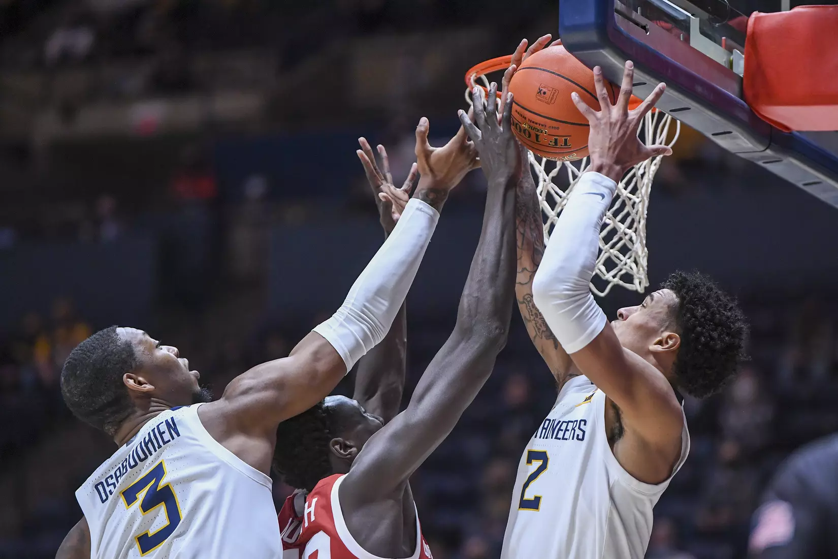 Jalen Bridges and Gabe Osabuohien fight for a rebound.