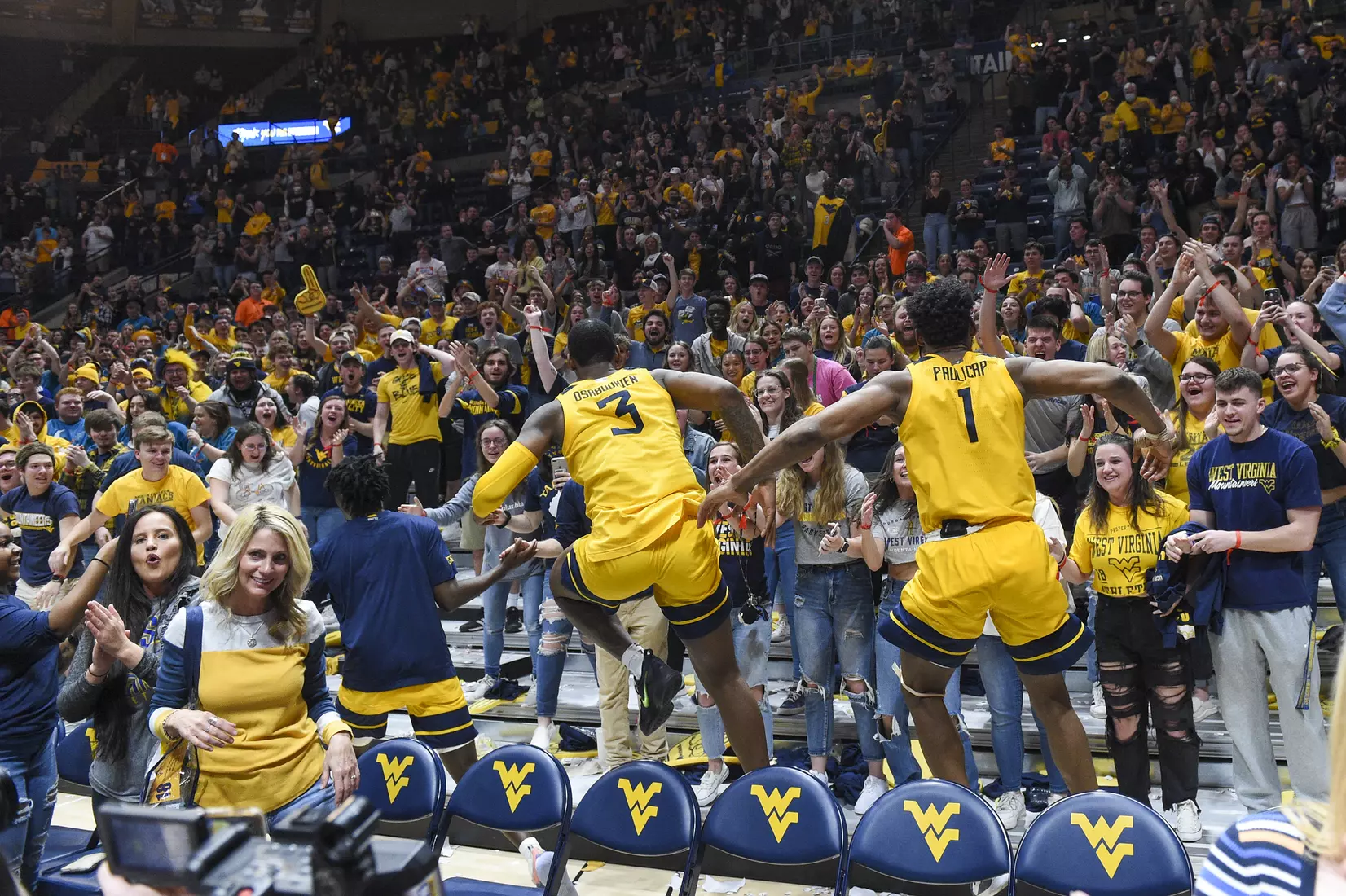 Gabe Osabuohien and Pauly Paulicap jump into the student section.