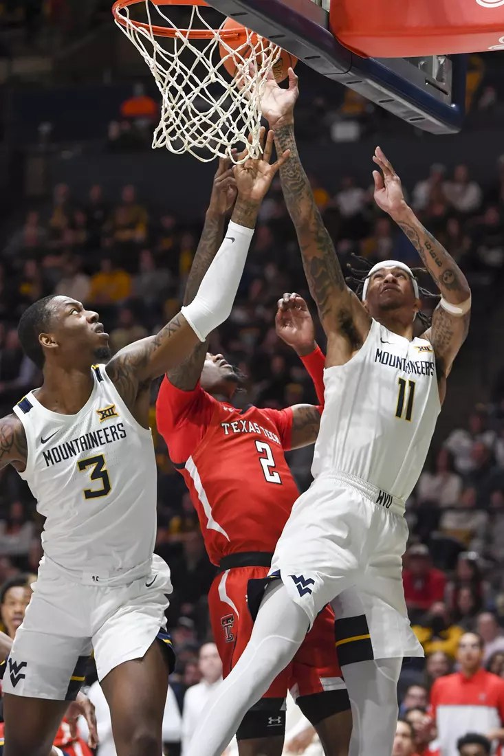 Jalen Bridges shoots while Gabe Osabuohien assists.