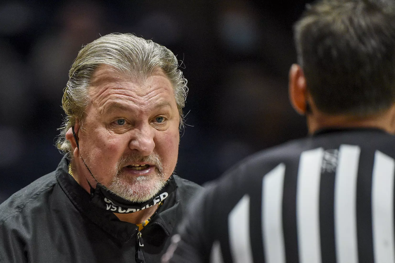 Bob Huggins talks with an official.