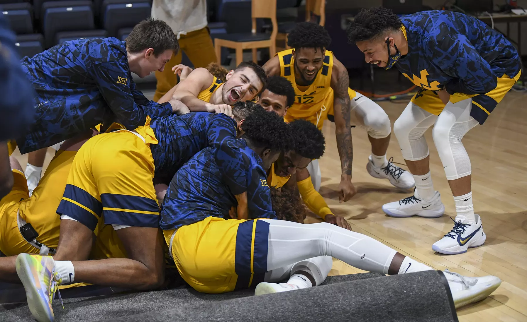 The Mountaineers mob Miles McBride after the buzzer.