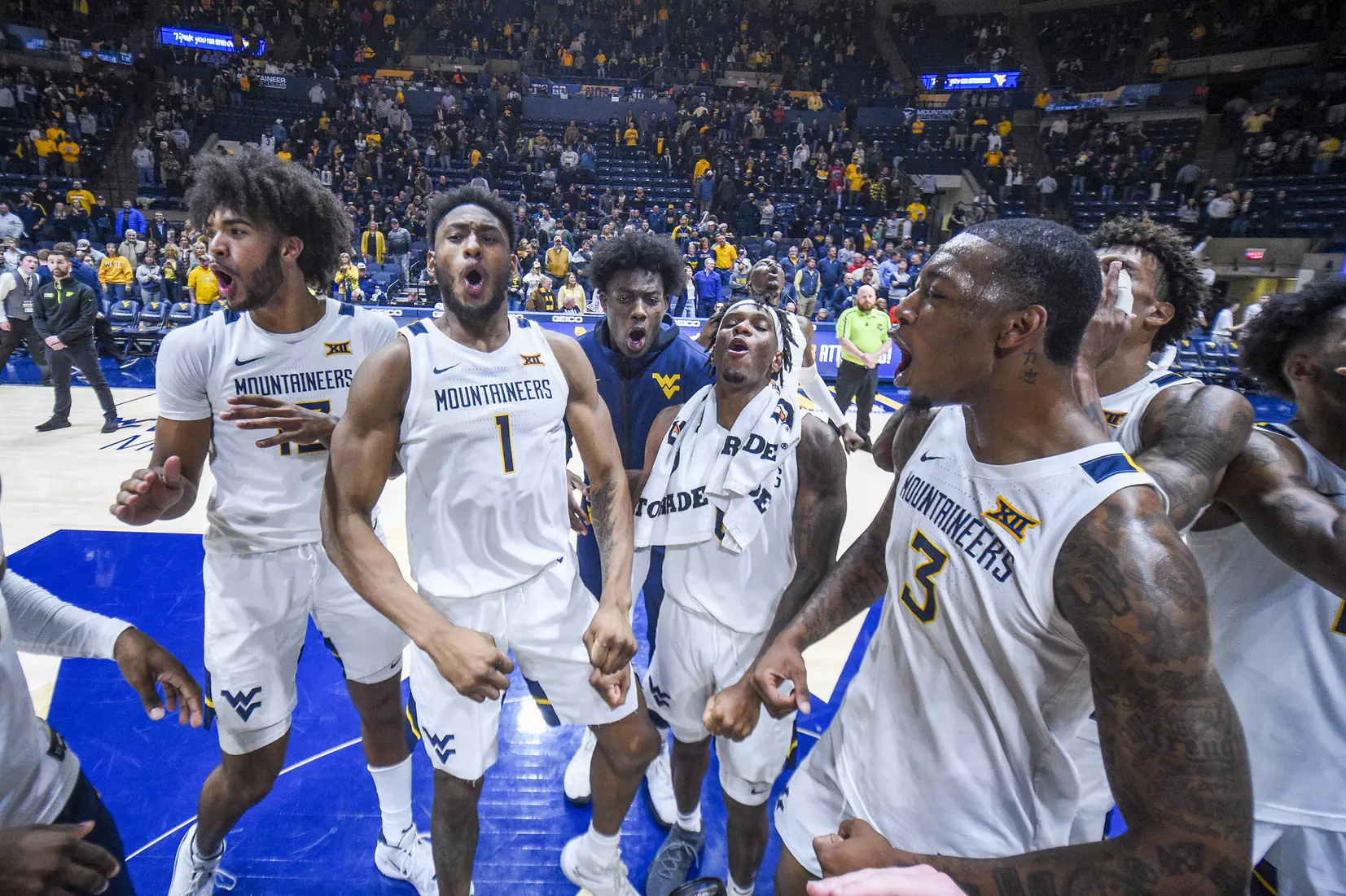 The Mountaineers celebrate the win over UConn.