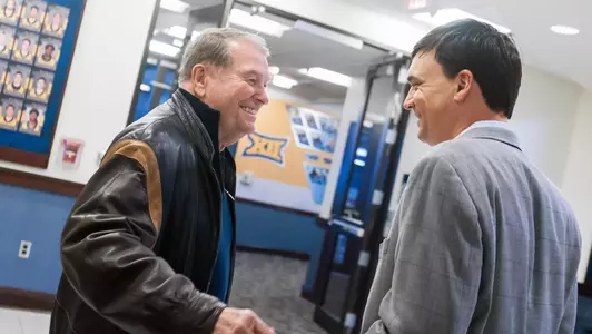 Hall of Fame coach Don Nehlen greets new West Virginia University football coach Neal Brown at the Milan Puskar Center in 2019.