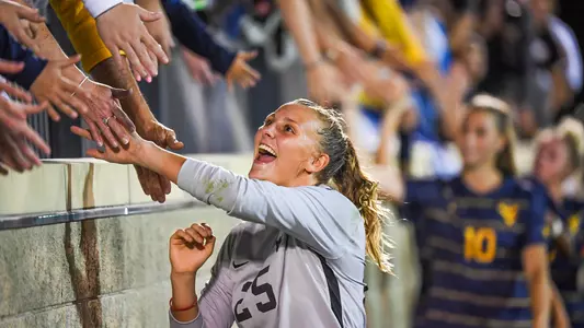 Goalkeeper Rylee Foster celebrates the shutout win with the fans.