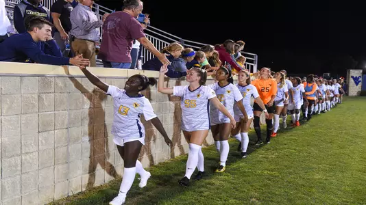 The Mountaineers celebrate the win over Duquesne.
