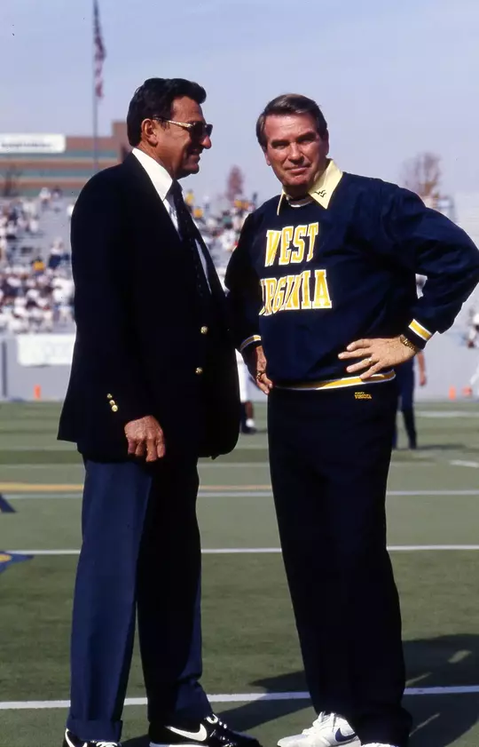Hall of Fame coaches Don Nehlen and Joe Paterno visit during pregame warmups prior to West Virginia's game against Penn State at Mountaineer Field in 1990.
