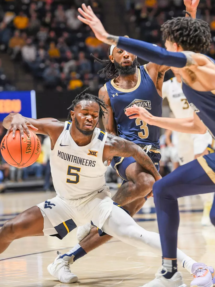 Joe Toussaint dribbles around defenders.