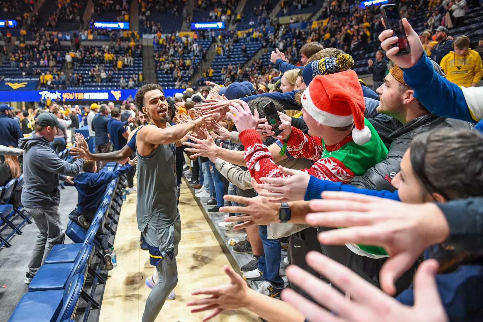 Emmitt Matthews Jr. leads the team through the student section.