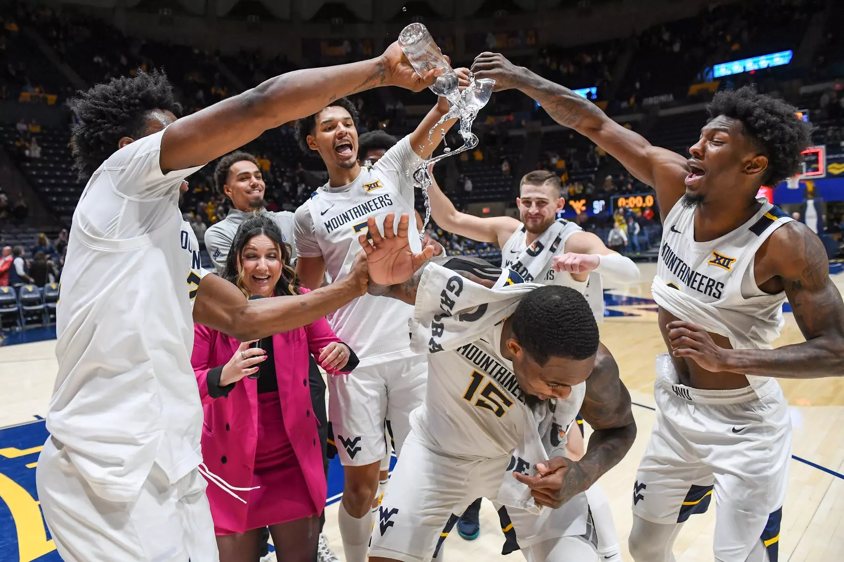 Jimmy Bell Jr. gets the water bath during a postgame TV interview from his teammates.