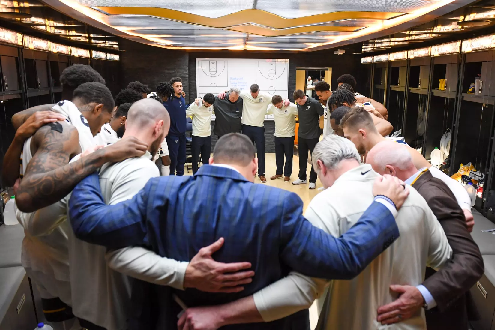 New Athletic Director Wren Baker joins in with the team and the Lord's Prayer postgame.
