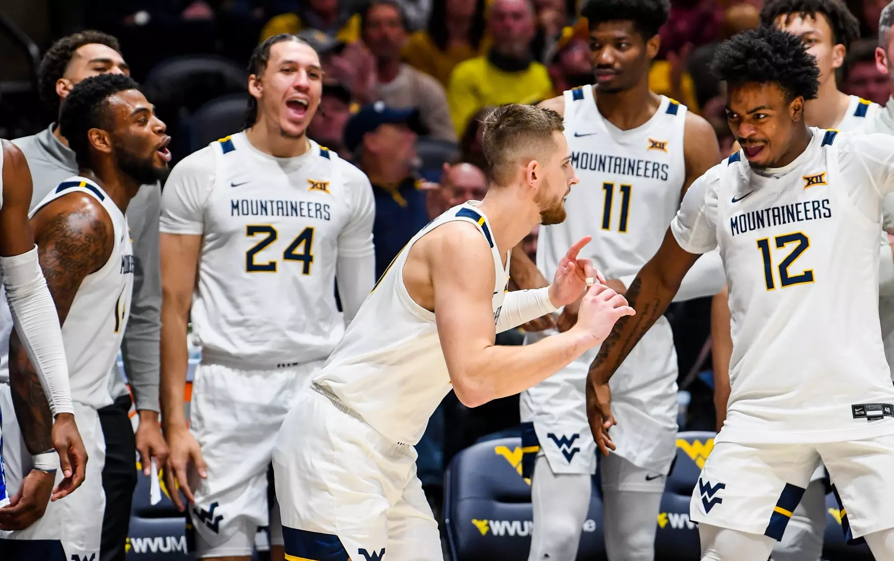 Erik Stevenson's teammates cheer his three-pointer.