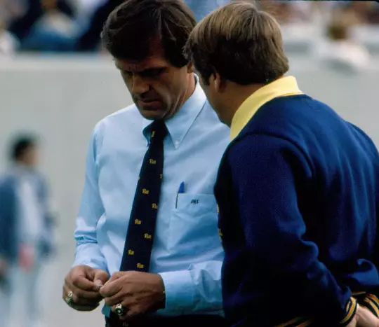 Jackie Sherrill and Don Nehlen visit during pregame warmups prior to West Virginia's game against Pitt at Mountaineer Field in 1981.