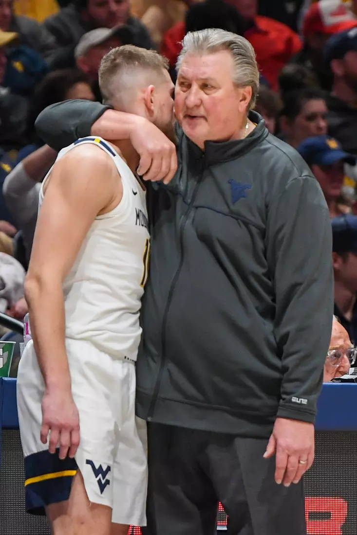 Bob Huggins gives Erik Stevenson a hug.