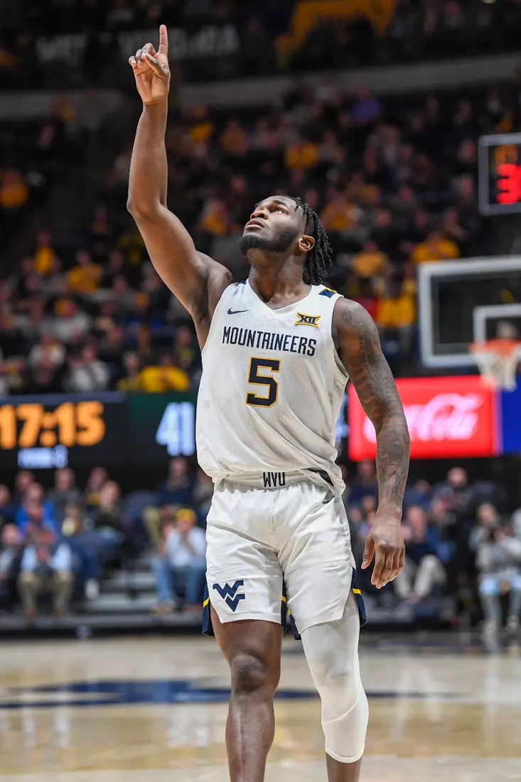 Joe Toussaint points skyward after a three.