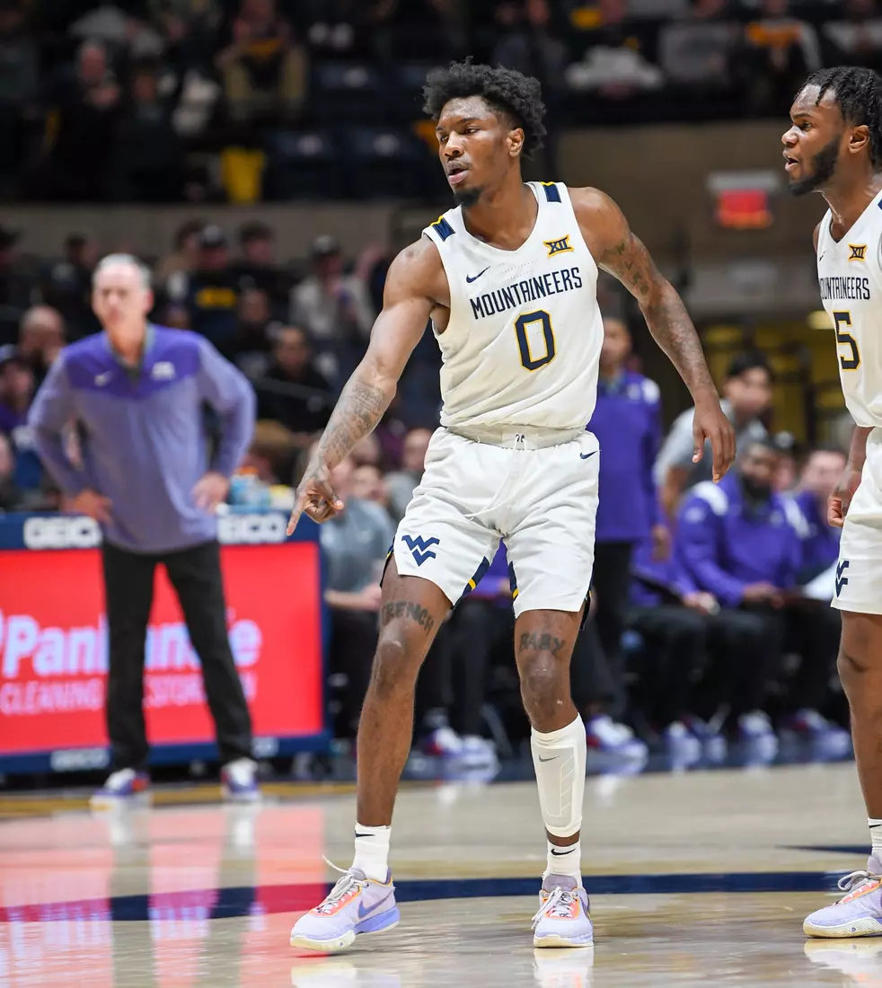 Kedrian Johnson points to the floor where his defender sits after the basket.