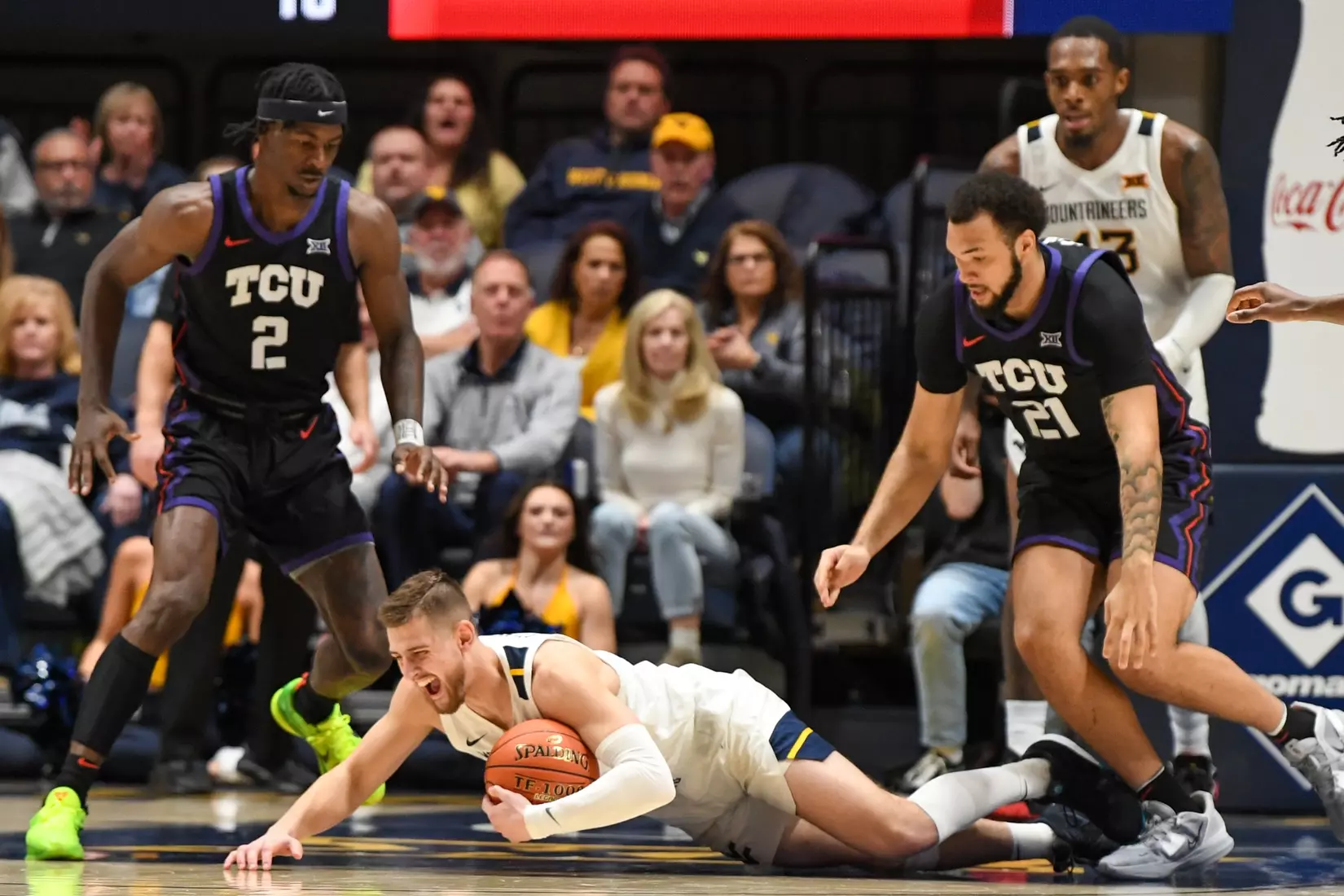 Erik Stevenson grabs the rebound and falls to the floor in pain.
