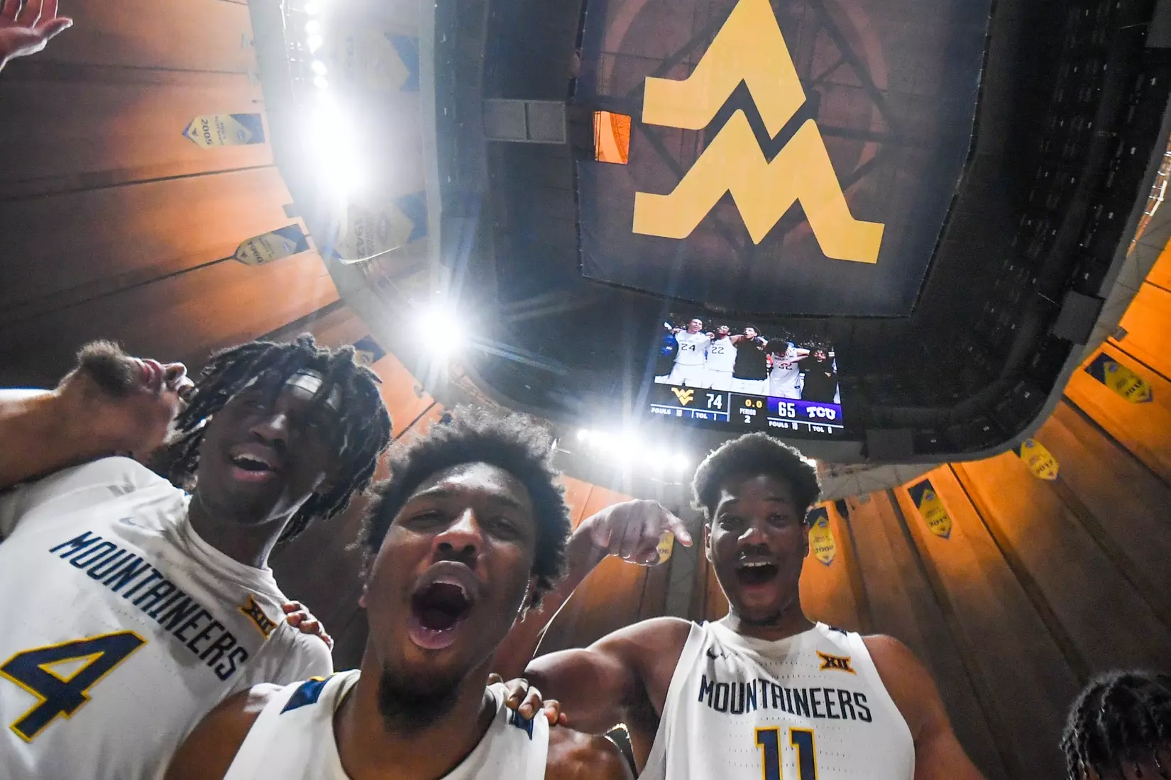 Kedrian Johnson and the Mountaineers celebrate the win over TCU.