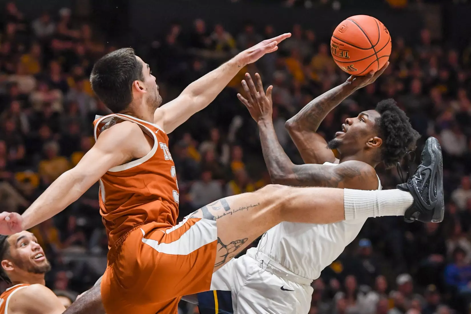 Kedrian Johnson shoots over a defender.
