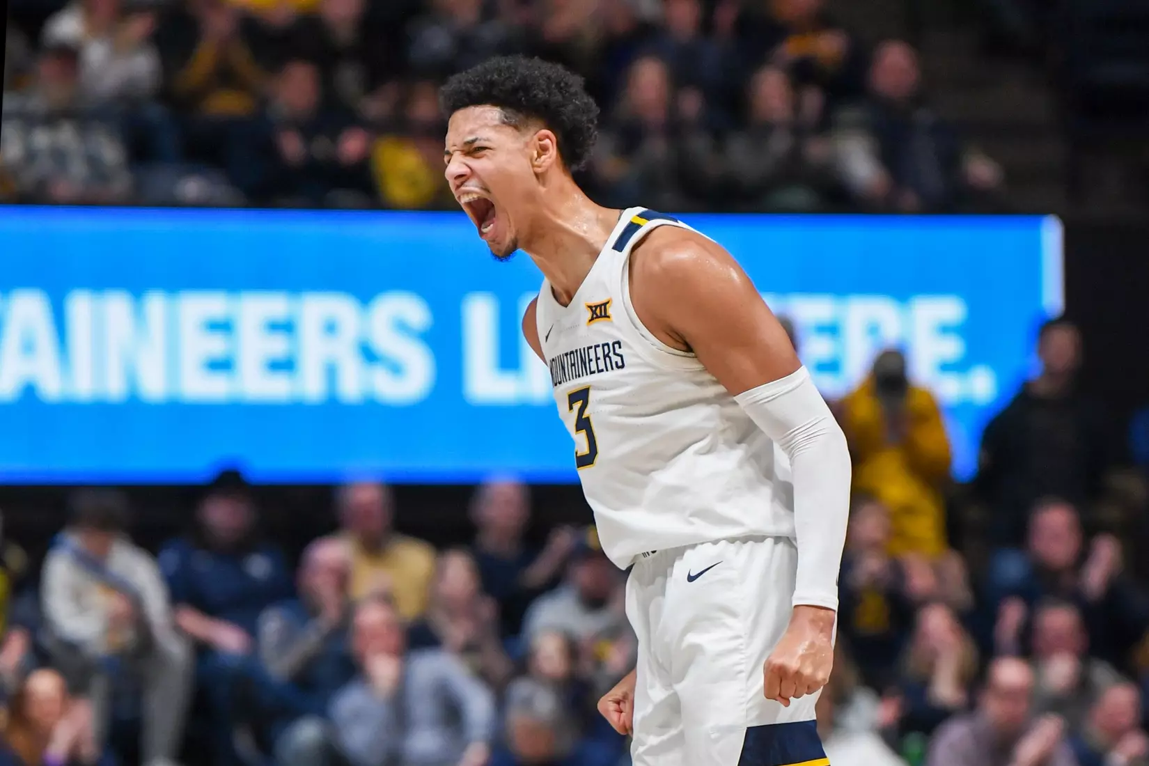 Tre Mitchell celebrates. three-pointer.