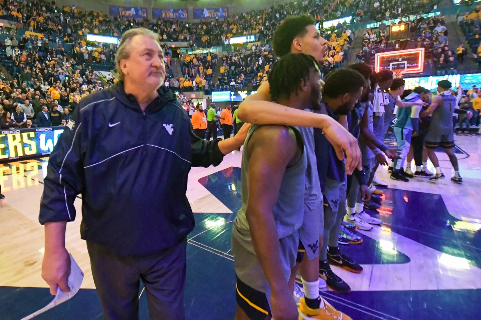 Bob Huggins joins his team for Country Roads.